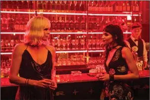  ?? The Associated Press ?? ALL DAGGER, NO CLOAK: Charlize Theron, left, and Sofia Boutella in “Atomic Blonde.”