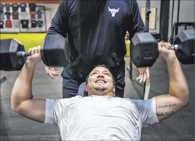  ??  ?? Second-year Raiders fullback Alec Ingold works out with weights on March 10 at Sports AdvantEdge, a gym in Verona, Wis. Ingold played collegiate­ly at Wisconsin.