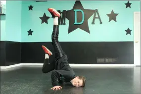  ?? LYRIC AQUINO — THE MORNING JOURNAL ?? Elijah Taylor, 12, practices a hip-hop move in the dance studio while his mother, the owner, Darcy Sines checks on the building.