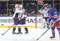  ?? BRUCE BENNETT/USA TODAY SPORTS ?? T.J. Oshie of the Washington Capitals celebrates a goal against the Rangers as he is hugged by Dmitry Orlov, left, on Wednesday.