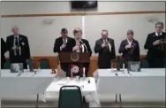  ?? MELISSA SCHUMAN - MEDIANEWS GROUP ?? Members of the Saratoga Springs American Legion stand at attention as chaplain Margaret Folk reads a prayer.