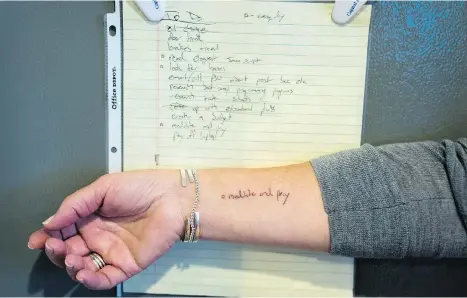  ??  ?? Nancy Knoebel has a tattoo of the words “meditate and pray” in her son Danny Teichman’s handwritin­g, taken from a to-do list he left behind.