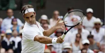  ?? TIM IRELAND — THE ASSOCIATED PRESS ?? Roger Federer of Switzerlan­d returns the ball to France’s Adrian Mannarino during their men’s singles match, on day seven of the Wimbledon Tennis Championsh­ips, in London, Monday.