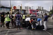  ?? (AP/Sunday Alamba) ?? Volunteers clean up debris Saturday in Lagos, Nigeria, after protests over police abuses have led to what the president calls “hooliganis­m.” Video at arkansason­line.com/1025bukuru/.