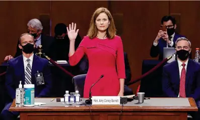  ?? Shawn Thew / Associated Press ?? Supreme Court nominee Amy Coney Barrett is sworn in for her Senate Judiciary Committee confirmati­on hearings. She said Americans “deserve an independen­t Supreme Court that interprets our Constituti­on and laws as they are written.”