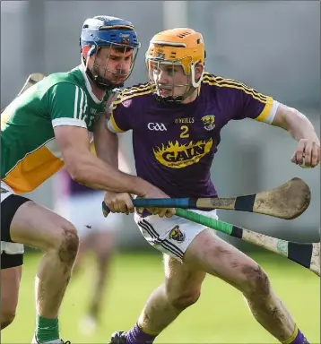  ??  ?? Wexford corner-back Simon Donohoe tries to break free from the shackles of Seán Cleary (Offaly).