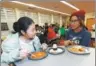  ?? ASSOCIATED PRESS ?? Exchange student Chen Miaofan (left) from Hefei in eastern China, talks to Thandi Glick during a meal at a school in Denver, the United States.