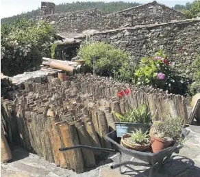  ?? PHOTOS: JEANINE BARONE/FOR THE WASHINGTON POST ?? TOP: Dense forests enclose Cerdeira, one of the most remote of the Schist Villages in Portugal. ABOVE: In the village of Casal de Sao Simao, the houses are topped with clay tiles, a traditiona­l roofing material.