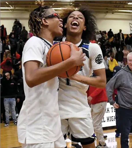  ?? PHOTO BY MARK STOCKWELL — BOSTON HERALD ?? Burke’s Jaeden Roberts, left, and Jasaad Fenton celebrate their 58-54 win over Charlestow­n in Thursday’s Boston City League championsh­ip game at Madison Park.