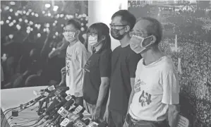  ?? KIN CHEUNG/AP FILE ?? Chow Hang-tung, second from left, seen Sunday, and other leaders of a Hong Kong activist group were arrested.