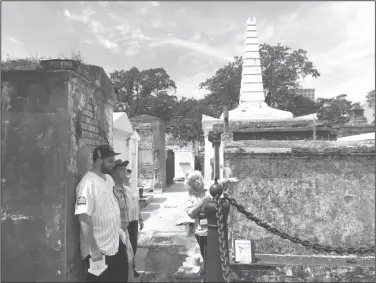  ?? Photos by Beth J. Harpaz/AP ?? Tour: This photo shows tour guide Jeanne Wilson of Save Our Cemeteries with a group of visitors at St. Louis Cemetery No. 1 in New Orleans. Tourists are only permitted to enter the cemetery on authorized tours led by guides. The regulation­s were...