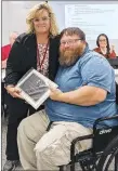  ?? Westside Eagle Observer/RANDY MOLL ?? Former board member John Skaggs receives a plaque from Superinten­dent Terrie DePaola at the Oct. 24 school board meeting for his service on the board.