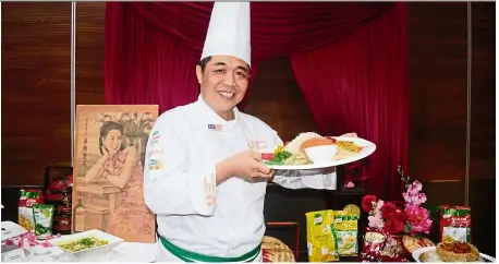  ??  ?? Wong and other Chinese chefs came up with a recipe book for Cny, which incorporat­es ideas for both traditiona­l Chinese meals as well as fusion dishes. Pictured here is Wong with his dish of yee sang with plum sauce infused with salted egg yolk powder. — uFC