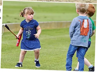 ??  ?? Horsing around: Mia brandishes a polo mallet as she plays with two little boys