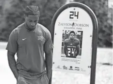  ?? ?? Former Middle Tennessee State football player Zack Dobson stops at the park named in honor of his brother, Zaevion Dobson, on March 25 in Knoxville, Tenn.