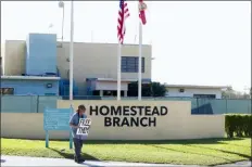  ?? WILFREDO LEE, FILE - THE ASSOCIATED PRESS ?? In this Feb. 19 file photo, Josh Rubin demonstrat­es in front of the Homestead Temporary Shelter for Unaccompan­ied Children, in Homestead, Fla. Federal officials say the Florida detention camp that has housed thousands of migrant children is emptying out. Health and Human Services Department spokeswoma­n Evelyn Stauffer said in an email Saturday, Aug. 3, that all children are either with family members or at smaller state-licensed facilities. The camp has housed about 14,300 undocument­ed children since March 2018.