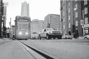  ?? [PHOTO BY BRYAN TERRY, THE OKLAHOMAN] ?? A streetcar moves east on Sheridan Avenue in Bricktown.