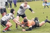  ??  ?? Dundee’s Alasdair Mackie crashes over the line in the win over Aberdeen Grammar.