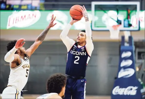  ?? Matt Slocum / Associated Press ?? UConn’s James Bouknight ( 2) goes up for a shot against Villanova’s Justin Moore during the second half on Saturday.