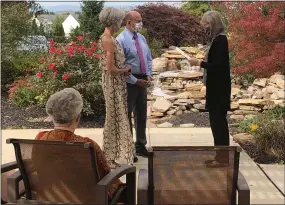  ?? COURTESY OF KEYSTONE VILLA AT FLEETWOOD ?? Keystone Villa at Fleetwood resident Brenda Walbert watches the wedding of her daughter Kathy Reed to Dr. Guy Piegari. Officiated by Berks Judge Mary Ann Ullman, the private ceremony was held on the outdoor patio at the independen­t living and personal care community in Maidencree­k Township.