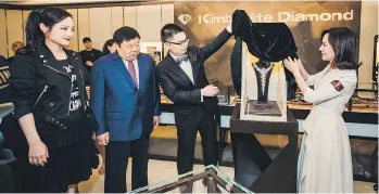  ??  ?? From left, Erica Chen, Dong Liusheng, Kellan Dong and Zhu WenJun unveil the $26-million Moon Goddess necklace at the grand opening of Kimberlite Diamond’s first North American store in Vancouver on Thursday.