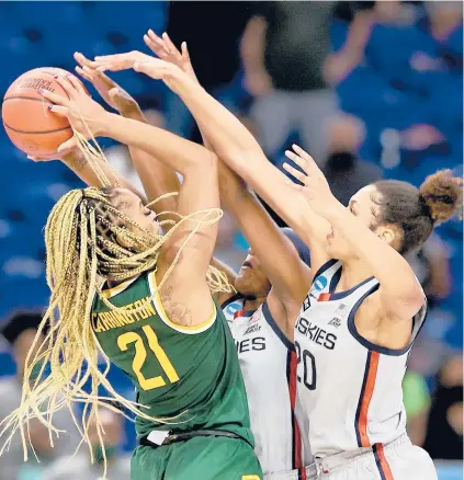  ?? ELSA/ GETTY ?? Baylor’s DiJonai Carrington is confronted by UConn’s Aaliyah Edwards (3) and Olivia Nelson-Ododa in the closing seconds of Monday’s game.