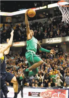  ?? Andy Lyons / Getty Images ?? Terry Rozier makes a go-ahead dunk in the final seconds of the Celtics’ 112-111 victory over the Pacers in Indianapol­is.