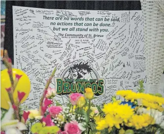  ?? LIAM RICHARDS THE CANADIAN PRESS ?? Flowers and other items are placed at a vigil and a memorial at Elgar Petersen Arena in Humboldt, Sask.