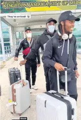  ?? CONTRIBUTE­D ?? English-based Reggae Boyz Kemar Roofe, Michail Antonio (centre) and Daniel Johnson carry their luggage after arriving at the Norman Manley Internatio­nal Airport in Kingston yesterday evening.
