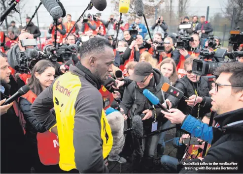  ??  ?? Usain Bolt talks to the media after
training with Borussia Dortmund