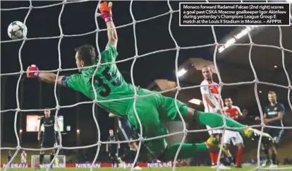  ??  ?? Monaco forward Radamel Falcao (2nd right) scores a goal past CSKA Moscow goalkeeper Igor Akinfeev during yesterday’s Champions League Group E match at the Louis II Stadium in Monaco. – AFPPIX