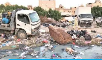  ??  ?? KUWAIT: Debris and vehicles parked randomly at an open square in Jleeb Al-Shuyoukh in this file photo.