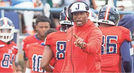  ?? BARBARA GAUNTT/CLARION LEDGER ?? Jackson State University Coach Deion Sanders shouts instructio­ns to his team during their game against Edward Waters at Mississipp­i Veterans Memorial Stadium on Feb. 21, 2021.