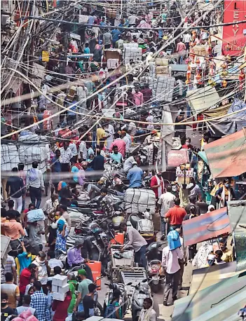  ?? — PTI ?? Crowd at Sadar Bazar market in New Delhi after authoritie­s eased lockdown restrictio­ns on Monday.