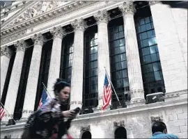  ?? Spencer Platt Getty Images ?? NOTHING HAS a bigger effect on a portfolio’s performanc­e than the behavior of the investor under duress. Above, outside the New York Stock Exchange in May.