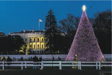  ?? Manuel Balce Ceneta / Associated Press ?? The National Christmas Tree glows on the Ellipse near the White House. President Trump’s administra­tion is going ahead with up to two dozen holiday events even as infections rise in the capital.