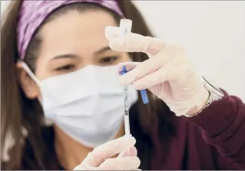  ?? Mario Tama / Getty Images ?? LA dose of the new one-shot Johnson & Johnson COVID-19 vaccine is prepared at a vaccinatio­n event in South Los Angeles on March 11 in Los Angeles, Calif.