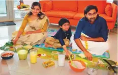  ?? Vishukkani. ?? ■ Gopikrishn­a Pillai enjoys sadhya at home with wife Ranjana and son Abhinav. He is particular about passing on Vishu traditions to his son. (Above left): Abhinav prays before the