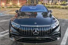  ?? KELLY YAMANOUCHI/ KELLYYAMAN­OUCHI@AJC.COM ?? A Mercedes-Benz AMG-EQS is ready for a test drive in Las Vegas. It has the luxury of tradition, while beckoning customers ready for an EV or curious about it. It has a 277-mile range, and can add 186 with a 15-minute charge.