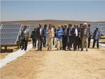  ?? (Elena Boffetta/AP Photo) ?? Officials tour a solar plant in a camp in Jordan