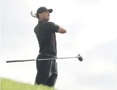  ??  ?? Tiger Woods reacts after playing his shot from the 12th tee during the first round of the Farmers Insurance Open at Torrey Pines South in San Diego, California. — AFP photo