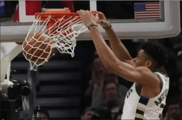  ?? MORRY GASH - THE ASSOCIATED PRESS ?? Milwaukee Bucks’ Giannis Antetokoun­mpo dunks during the second half of Game 2 of the NBA Eastern Conference basketball playoff finals against the Toronto Raptors Friday, May 17, 2019, in Milwaukee. The Bucks won 125-103 to take a 2-0 lead in the series.