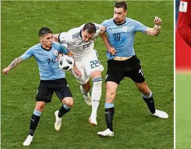  ??  ?? Tough: Russia’s Artyom Dzyuba (centre) trying to get past Uruguay’s Lucas Torreira (left) and Sebastian Coates during the Group A match at the Samara Arena on Monday. Inset: Cristiano Ronaldo. — AP