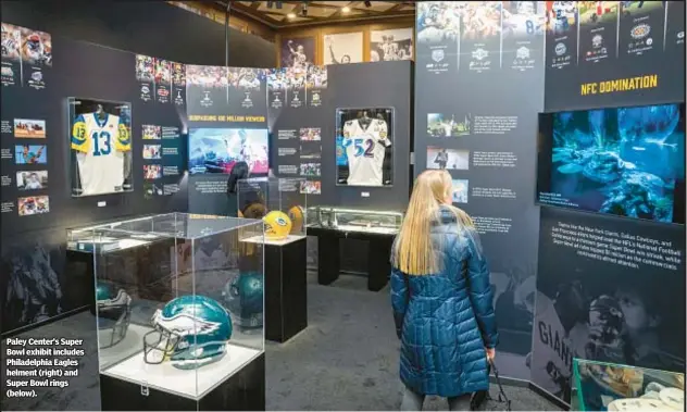  ?? ?? Paley Center’s Super Bowl exhibit includes Philadelph­ia Eagles helment (right) and Super Bowl rings (below).