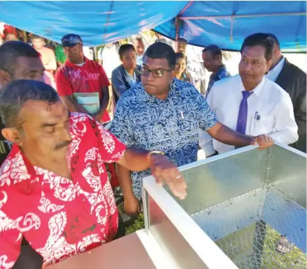  ?? Photo: Ministry of Agricultur­e ?? Madhuvani Farmer, Pravin Kumar (front left) explains how the rice drier works to Minister for Agricultur­e, Waterways and Environmen­t, the Mahendra Reddy (middle).