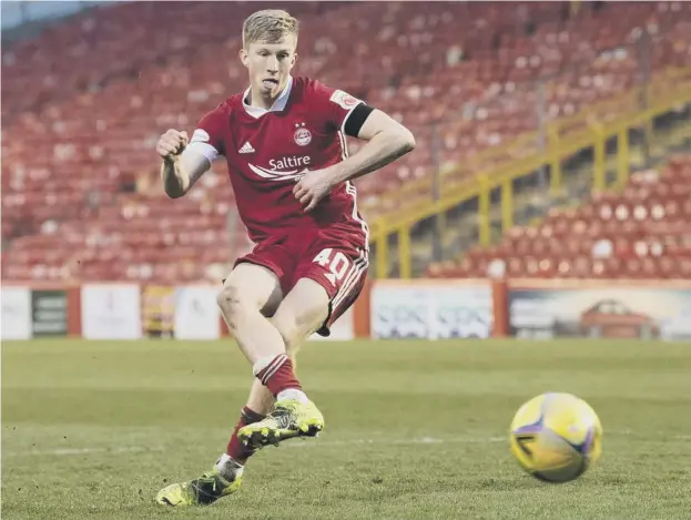  ??  ?? 0 Ross Mccrorie keeps his cool to score the winning penalty for Aberdeen in Saturday’s Scottish Cup shootout against Livingston at Pittodrie