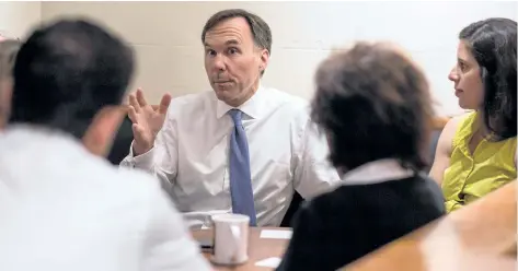 ?? BEN NELMS/THE CANADIAN PRESS ?? Finance Minister Bill Morneau speaks with small business owners at a coffee shop in Vancouver, B.C., on Tuesday ahead of a Liberal caucus retreat in Kelowna.