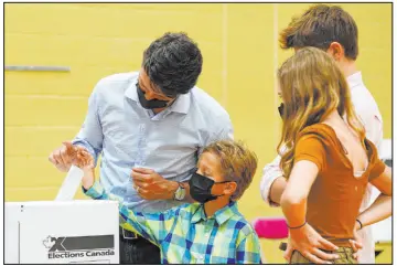  ?? Sean Kilpatrick The Associated Press ?? Liberal leader Justin Trudeau casts his ballot Monday in the 44th general federal election as he’s joined by his children, Xavier, Ella-grace and Hadrien, in Montreal.