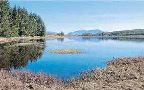  ??  ?? REFLECTION­S: The tranquil beauty of
Loch Bhac on a sunny day.