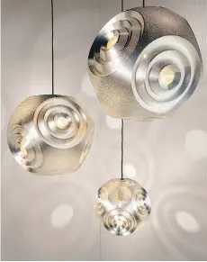  ??  ?? Tom Dixon’s pendant lights from his Curve collection. Dixon’s new work features aluminum, stone, glass, wax, wood, brass and iron.